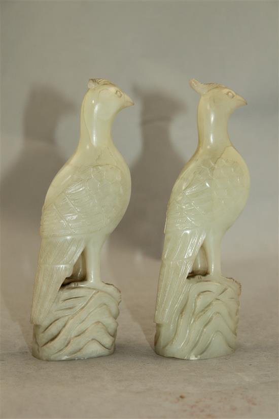 A pair of celadon-white jade standing figures of pheasants, 20th century, 4.3cm, chips to crests